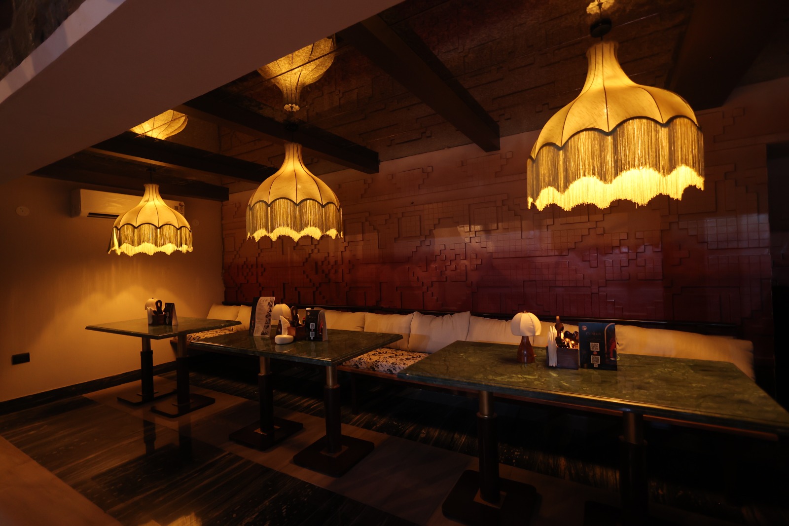 Intimate indoor booths with fringe chandeliers